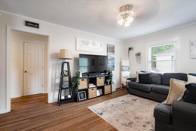 1159 Echles St, Memphis, TN 38111 - living area with ornamental molding, wood finished floors, ceiling fan, a textured ceiling, and baseboards