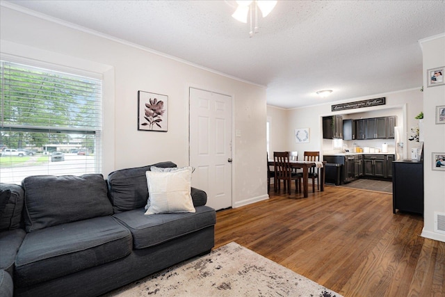 1159 Echles St, Memphis, TN 38111 - living area with crown molding, dark wood-type flooring, a textured ceiling, baseboards, and ceiling fan