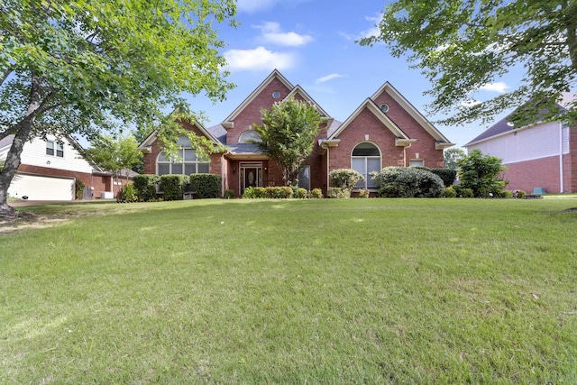 420 Estanaula Rd, Collierville, TN 38017 - traditional-style house with brick siding, a front yard, and a garage