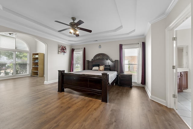 420 Estanaula Rd, Collierville, TN 38017 - bedroom featuring a raised ceiling, multiple windows, wood finished floors, arched walkways, and crown molding