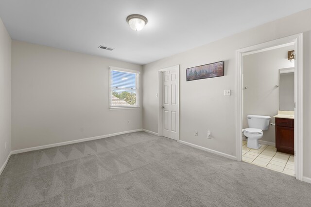 420 Estanaula Rd, Collierville, TN 38017 - unfurnished bedroom with light carpet, baseboards, connected bathroom, and light tile patterned floors