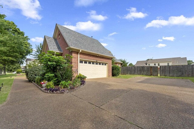 420 Estanaula Rd, Collierville, TN 38017 - view of side of property with roof with shingles, driveway, and brick siding