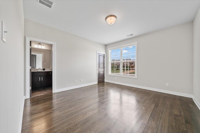6159 Upper Granger St, Arlington, TN 38002 - unfurnished room featuring dark wood-style flooring, baseboards, and a sink