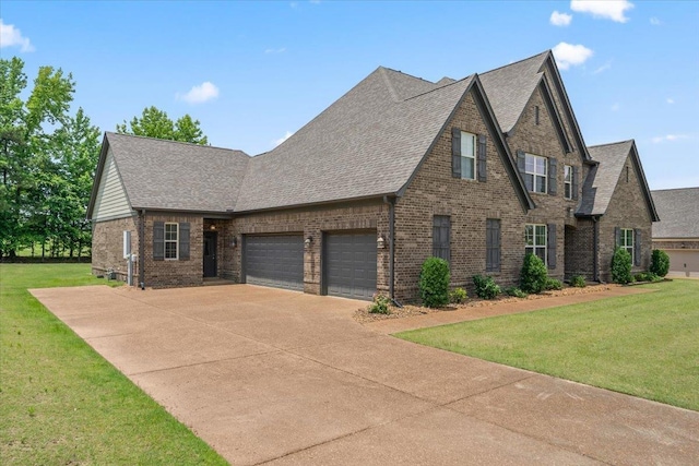 6159 Upper Granger St, Arlington, TN 38002 - view of front of home with brick siding, an attached garage, concrete driveway, and a front lawn