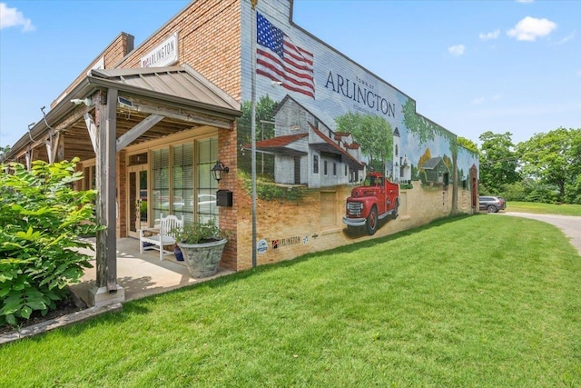 6159 Upper Granger St, Arlington, TN 38002 - view of property exterior with a standing seam roof, a yard, brick siding, and metal roof