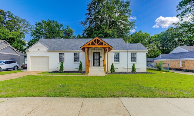 4009 Hemingway Ave, Memphis, TN 38128 - view of front of home featuring an attached garage, a front yard, and brick siding