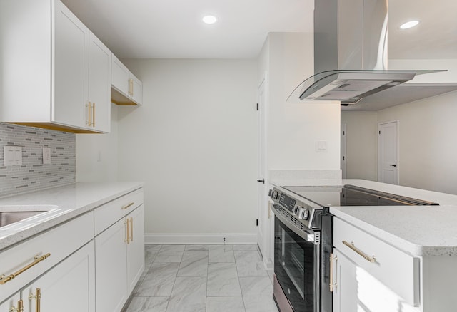 4009 Hemingway Ave, Memphis, TN 38128 - kitchen with stainless steel electric range, island exhaust hood, light marble finish floors, recessed lighting, and white cabinets