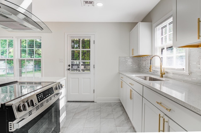 4009 Hemingway Ave, Memphis, TN 38128 - kitchen with range hood, stainless steel electric range, decorative backsplash, light stone countertops, and light marble finish floors