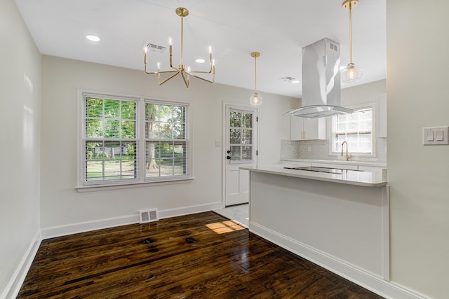 4009 Hemingway Ave, Memphis, TN 38128 - kitchen featuring a chandelier, plenty of natural light, white cabinetry, and tasteful backsplash