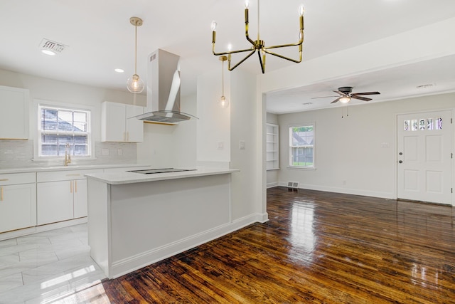 4009 Hemingway Ave, Memphis, TN 38128 - kitchen featuring island exhaust hood, a sink, light countertops, decorative backsplash, and white cabinets