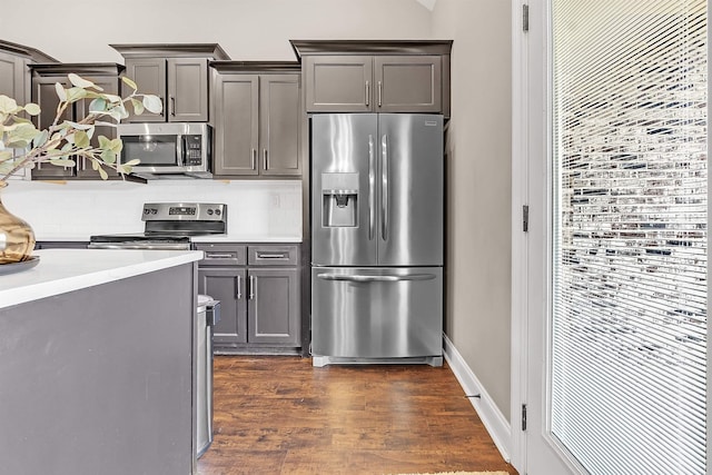 7415 Lost Grove Ln, Cordova, TN 38016 - kitchen featuring appliances with stainless steel finishes, tasteful backsplash, dark wood-type flooring, light countertops, and gray cabinets