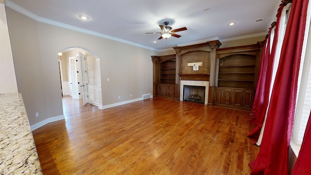 4111 Sir Thopas Dr, Southaven, MS 38671 - unfurnished living room featuring ceiling fan, arched walkways, wood finished floors, recessed lighting, and a fireplace