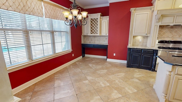 4111 Sir Thopas Dr, Southaven, MS 38671 - kitchen featuring range with two ovens, a chandelier, backsplash, ornamental molding, and cream cabinets
