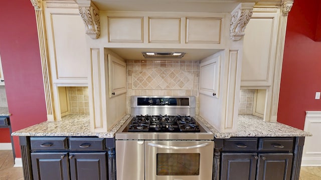 4111 Sir Thopas Dr, Southaven, MS 38671 - kitchen featuring stainless steel gas stove, tasteful backsplash, and light stone countertops