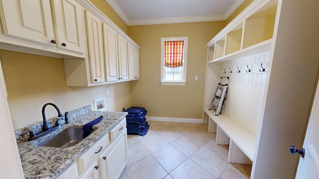 4111 Sir Thopas Dr, Southaven, MS 38671 - washroom featuring cabinet space, washer hookup, ornamental molding, and light tile patterned floors