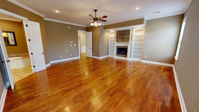 4111 Sir Thopas Dr, Southaven, MS 38671 - unfurnished living room featuring built in features, a ceiling fan, light wood finished floors, a fireplace, and ornamental molding