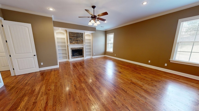 4111 Sir Thopas Dr, Southaven, MS 38671 - unfurnished living room with plenty of natural light, a ceiling fan, ornamental molding, built in shelves, and recessed lighting