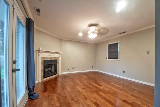 4737 Sequoia Ave, Memphis, TN 38117 - unfurnished living room with ceiling fan, dark wood-style floors, a tiled fireplace, and ornamental molding