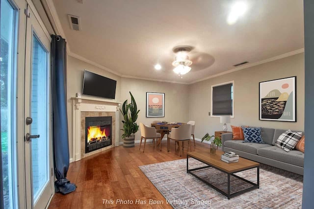 4737 Sequoia Ave, Memphis, TN 38117 - living area featuring wood finished floors, crown molding, a tiled fireplace, and ceiling fan