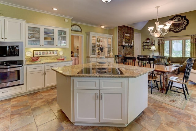 2994 Oakleigh Ln, Germantown, TN 38138 - kitchen with appliances with stainless steel finishes, white cabinets, light stone finish flooring, light stone counters, and ornamental molding