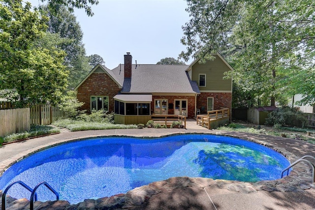 2994 Oakleigh Ln, Germantown, TN 38138 - view of pool with a deck, a storage unit, and a sunroom