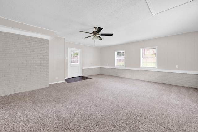 3051 Overbrook Dr, Memphis, TN 38128 - carpeted empty room featuring brick wall, ceiling fan, and a textured ceiling