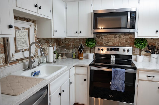 475 N Highland St Unit 3H, Memphis, TN 38122 - kitchen with stainless steel appliances, light countertops, white cabinetry, and tasteful backsplash