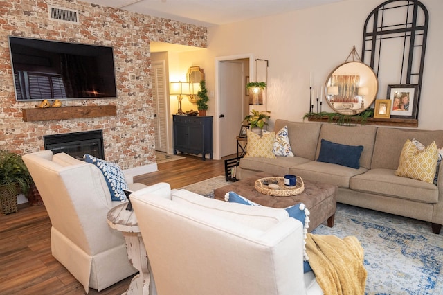 475 N Highland St Unit 3H, Memphis, TN 38122 - living room featuring wood finished floors and a brick fireplace