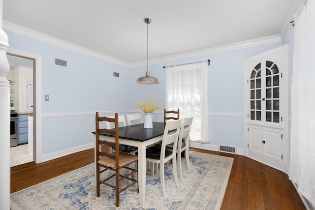 1856 N Rainbow Dr, Memphis, TN 38107 - dining space featuring wood-type flooring and crown molding