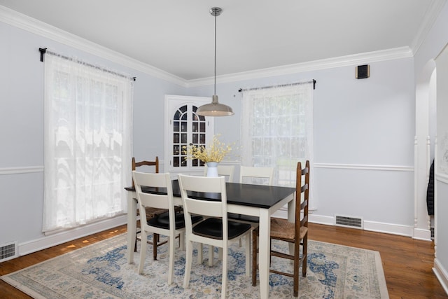 1856 N Rainbow Dr, Memphis, TN 38107 - dining area featuring crown molding, wood finished floors, and arched walkways