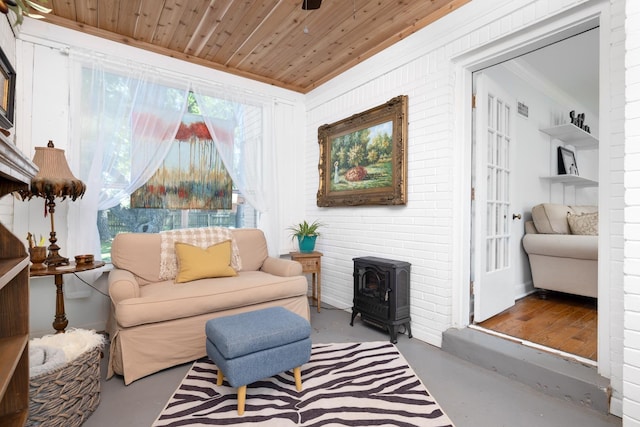 1856 N Rainbow Dr, Memphis, TN 38107 - living area with a wood stove, finished concrete floors, ornamental molding, and wooden ceiling
