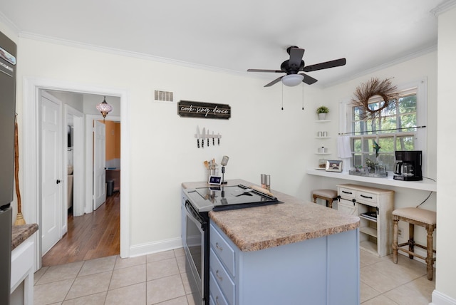 1856 N Rainbow Dr, Memphis, TN 38107 - kitchen with electric range, ornamental molding, ceiling fan, blue cabinetry, and light tile patterned flooring