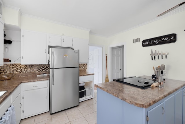 1856 N Rainbow Dr, Memphis, TN 38107 - kitchen with freestanding refrigerator, open shelves, backsplash, ornamental molding, and white cabinetry