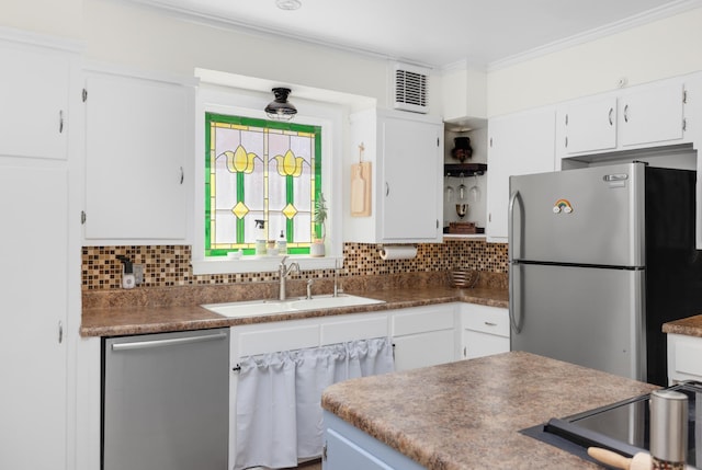1856 N Rainbow Dr, Memphis, TN 38107 - kitchen featuring appliances with stainless steel finishes, white cabinetry, backsplash, ornamental molding, and open shelves