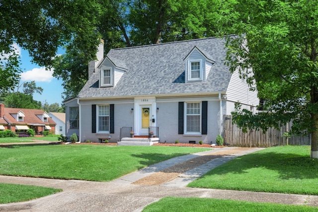 1856 N Rainbow Dr, Memphis, TN 38107 - cape cod home with a shingled roof, a chimney, and brick siding