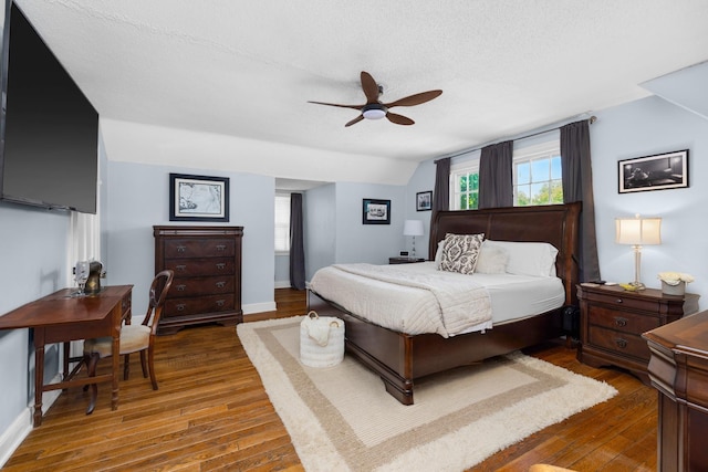 1856 N Rainbow Dr, Memphis, TN 38107 - bedroom with wood-type flooring, multiple windows, a textured ceiling, a ceiling fan, and vaulted ceiling