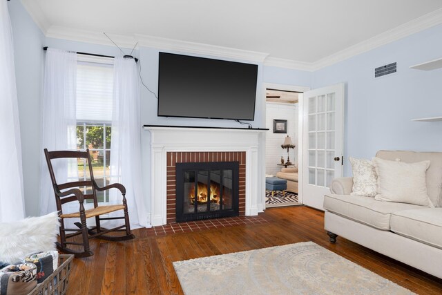 1856 N Rainbow Dr, Memphis, TN 38107 - living area featuring wood-type flooring, crown molding, and a brick fireplace