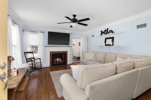 1856 N Rainbow Dr, Memphis, TN 38107 - living area with crown molding, ceiling fan, dark wood finished floors, and a brick fireplace