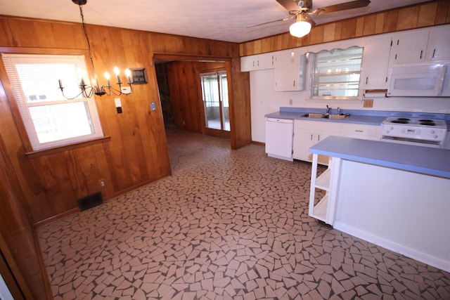 3642 Charlene Rd, Bartlett, TN 38135 - kitchen featuring white appliances, wooden walls, white cabinetry, a ceiling fan, and a chandelier