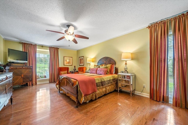 2155 Wickersham Ln, Germantown, TN 38139 - bedroom with a textured ceiling, ornamental molding, wood finished floors, and ceiling fan