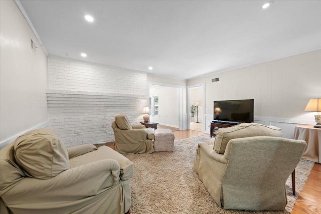 1469 Poplar Estates Pkwy, Germantown, TN 38138 - living room featuring crown molding, wood finished floors, recessed lighting, and brick wall