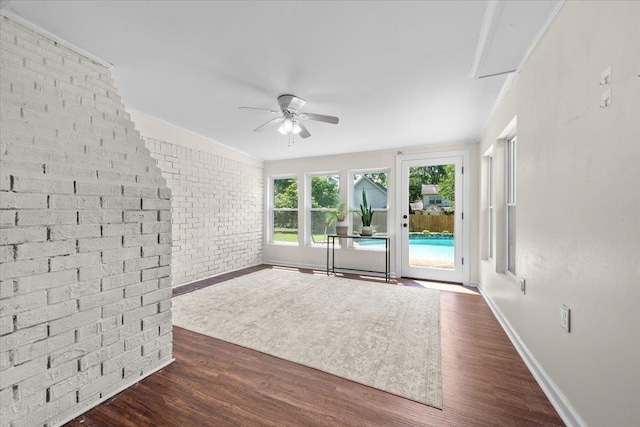 1469 Poplar Estates Pkwy, Germantown, TN 38138 - unfurnished room with ceiling fan, dark wood-type flooring, and brick wall