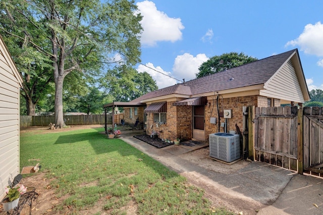 6385 Easthampton Cv, Bartlett, TN 38134 - back of house featuring roof with shingles, a gate, a fenced backyard, brick siding, and a patio area