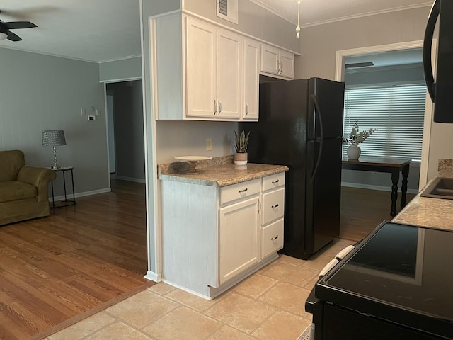 7241 Renda St, Millington, TN 38053 - kitchen with black appliances, ornamental molding, white cabinets, a ceiling fan, and light countertops