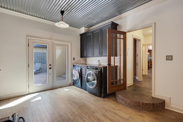 236 Riveredge Cv, Memphis, TN 38018 - laundry room featuring separate washer and dryer, french doors, crown molding, light wood-style floors, and cabinet space