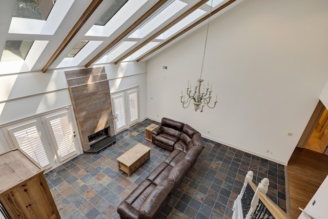 236 Riveredge Cv, Memphis, TN 38018 - living room featuring a skylight, high vaulted ceiling, a chandelier, beamed ceiling, and a fireplace