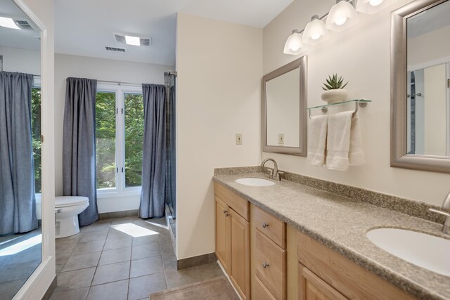 236 Riveredge Cv, Memphis, TN 38018 - bathroom featuring double vanity, plenty of natural light, tile patterned flooring, and curtained shower
