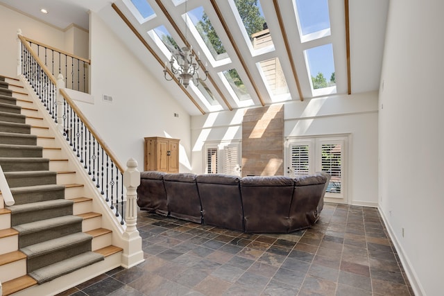 236 Riveredge Cv, Memphis, TN 38018 - living area with a high ceiling, a skylight, stairway, and stone tile flooring