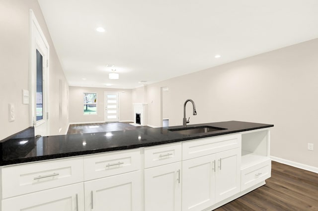 3374 Given Ave, Memphis, TN 38122 - kitchen featuring dark wood-style flooring, white cabinets, dark stone counters, a fireplace, and open floor plan