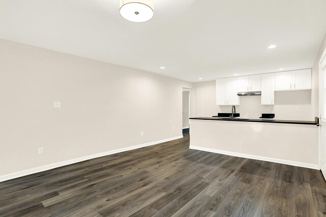 3374 Given Ave, Memphis, TN 38122 - kitchen featuring dark wood-style flooring, dark countertops, white cabinets, recessed lighting, and under cabinet range hood